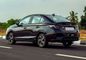 Honda City Driving: Rear Left Three Quarter View Honda City Driving: Rear Left Three Quarter View