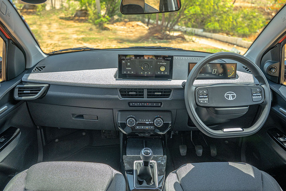 Tata Tiago The dashboard looks modern with twin free standing displays and the fabric insert dials up the premiumness