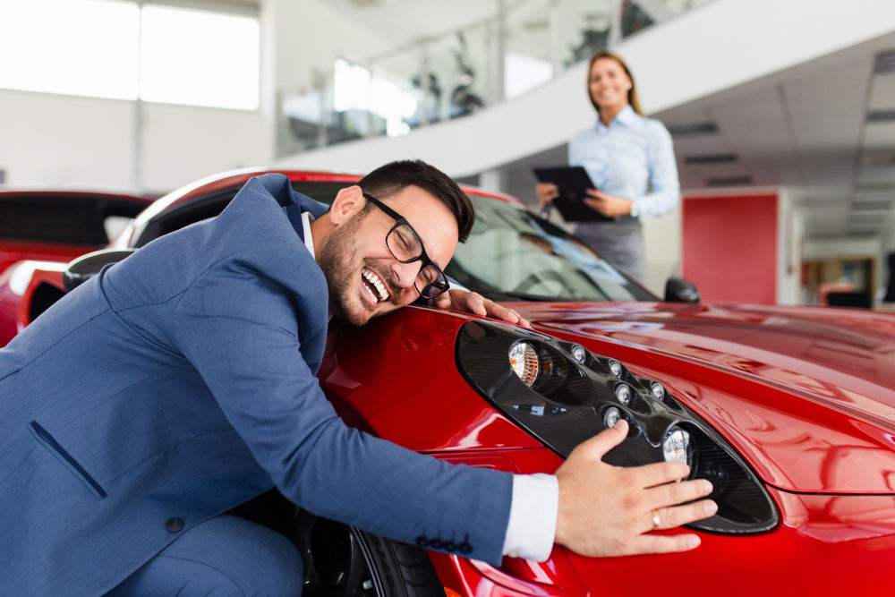 person hugging a car
