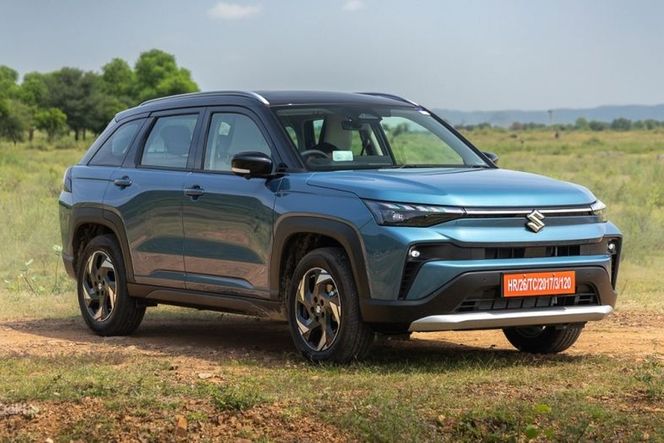 Maruti Suzuki Victoris in blue with black roof, parked on a dirt field Maruti Suzuki Victoris in blue with black roof, parked on a dirt field