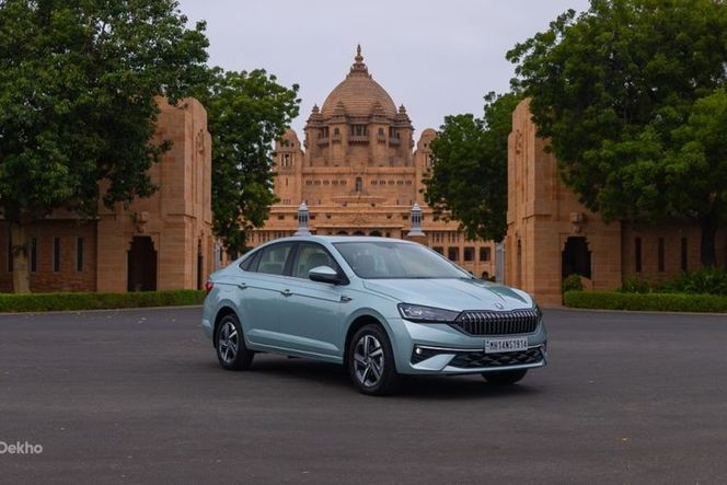 New Skoda Slavia in light blue-green, parked in front of a palace New Skoda Slavia in light blue-green, parked in front of a palace