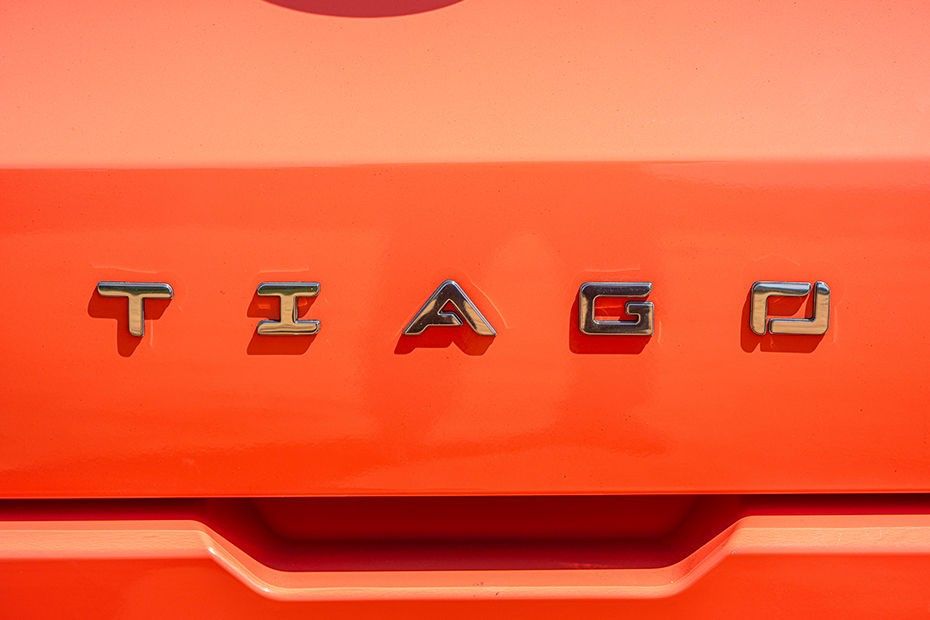 Tata Tiago chrome name lettering on an orange tailgate above the handle