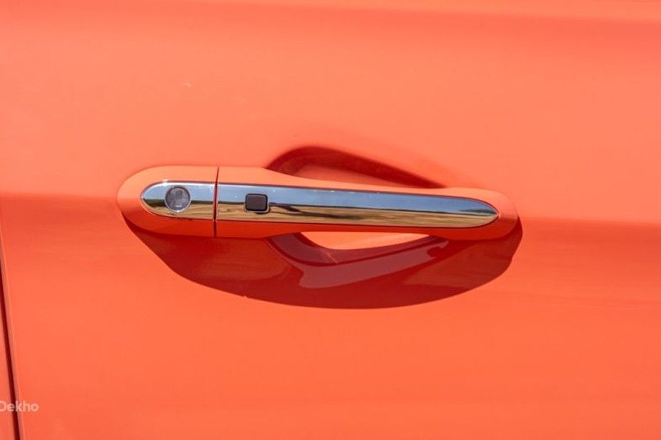 Tata Tiago chrome front door handle with request button on orange body panel