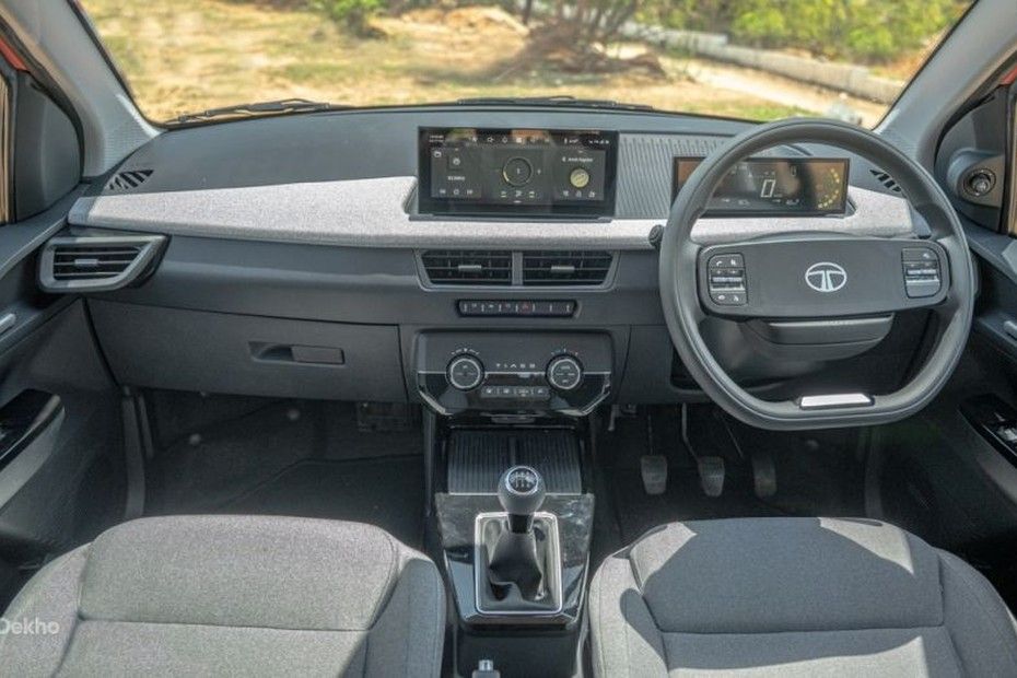 Tata Tiago dashboard with touchscreen, digital cluster, fabric trim and manual gear lever.