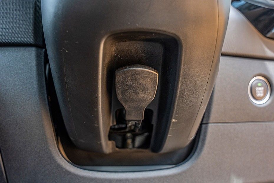 Tata Tiago steering column lever for height adjustment, with start-stop button beside it
