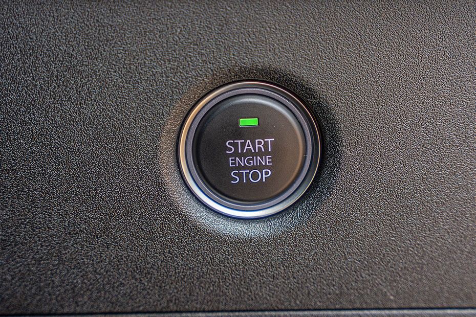 Tata Tiago engine start stop button on textured black dashboard trim