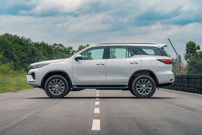 Toyota Fortuner in white, parked side-on on a test track road Toyota Fortuner in white, parked side-on on a test track road