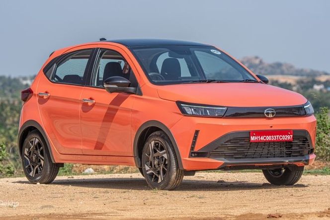 Tata Tiago in orange with black roof, front three-quarter view, parked outdoors Tata Tiago in orange with black roof, front three-quarter view, parked outdoors