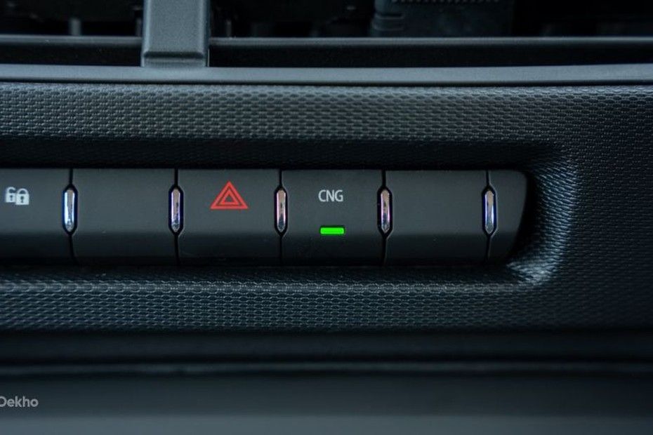 Tata Tiago dashboard button row with hazard switch and lit CNG mode button