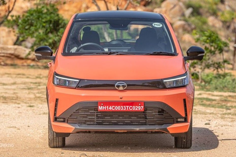 Tata Tiago front view in orange with black roof, LED headlamps and grille