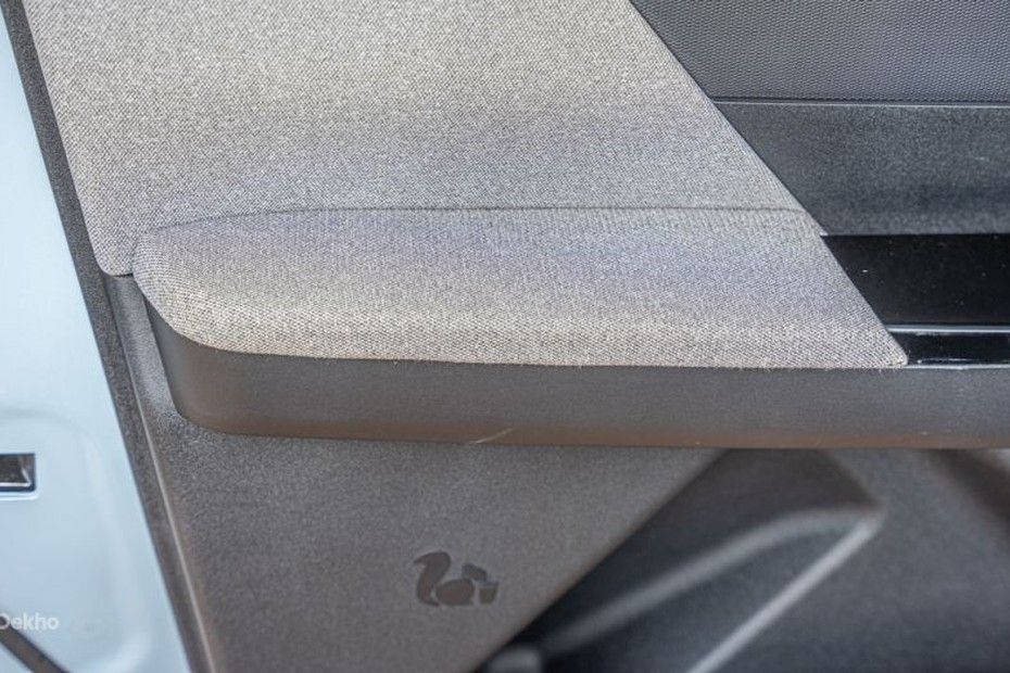 Tata Tiago front door pad with grey fabric armrest and dark plastic trim
