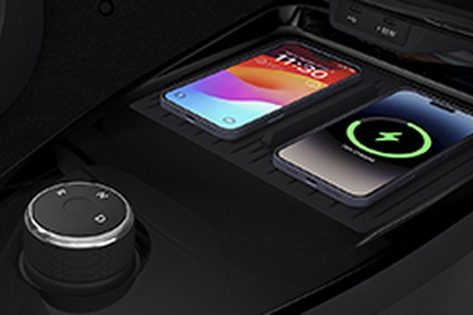 Tata Tiago rotary AMT gear knob beside two phones on charging deck