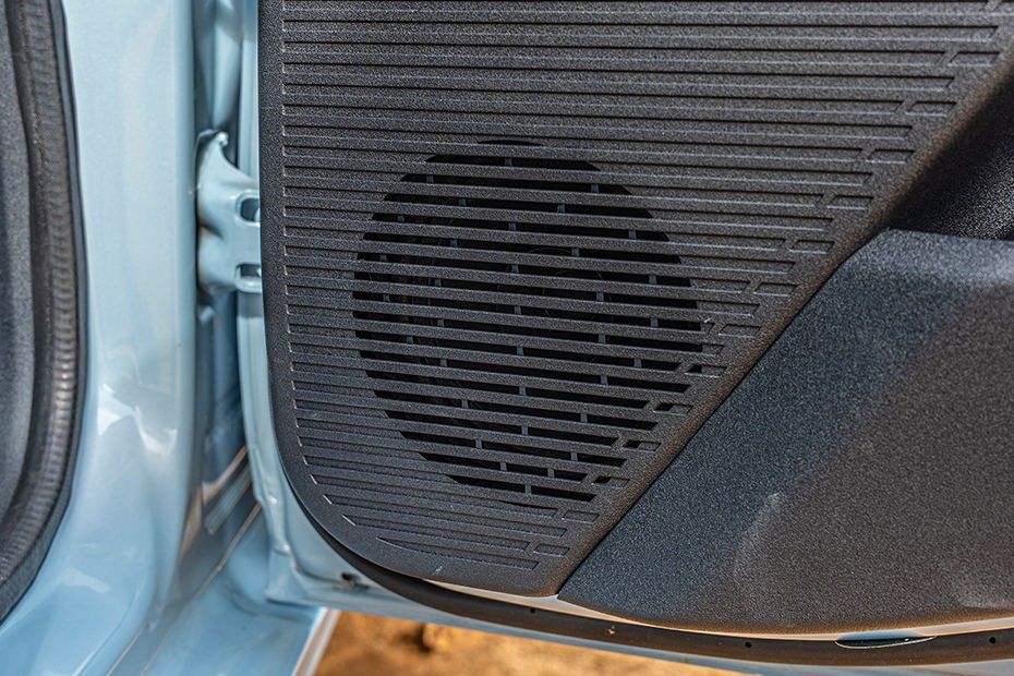 Tata Tiago rear door speaker grille on black textured door panel