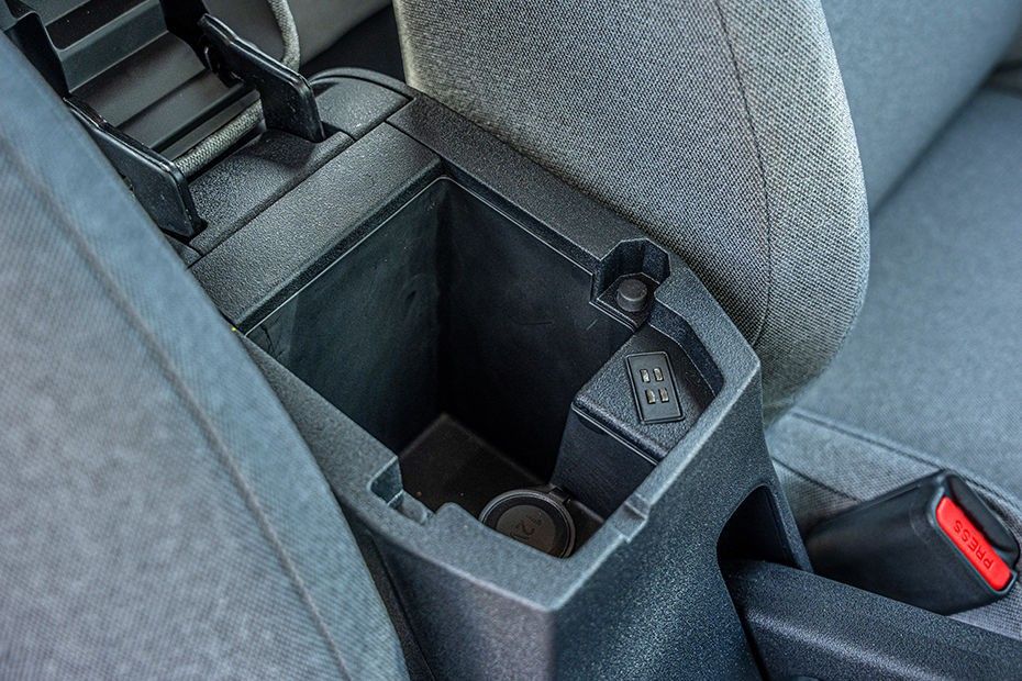 Tata Tiago front armrest storage bin open, showing 12V socket and charging port