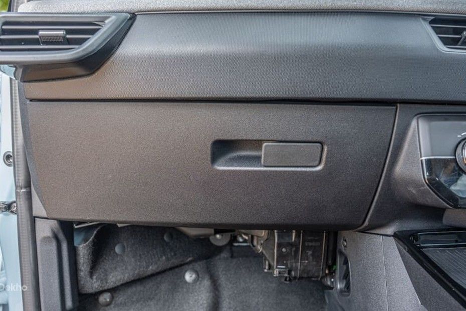 Tata Tiago glovebox on the passenger side of a dark textured dashboard