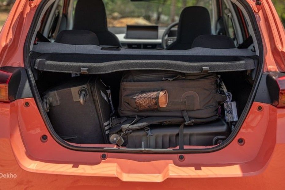 Tata Tiago open boot holding a cabin suitcase and backpacks under parcel shelf